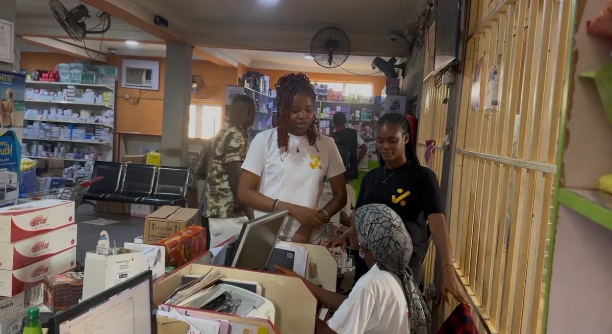Saletick agents in Saletick t-shirts helping the staff of a pharmacy at their counter